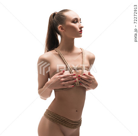 Topless slim female model tied with ropes 72272913