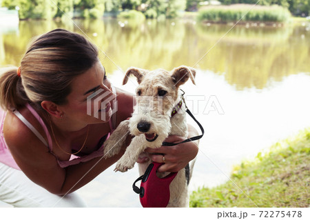 pretty woman with cute dog fox terrier playing in green sunny park, lifestyle people concept pretty woman with cute dog fox terrier playing in green sunny park, lifestyle people concept 72275478