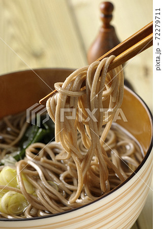刻み葱とわかめがトッピングされたシンプルな掛け蕎麦を食べる 刻み葱とわかめがトッピングされたシンプルな掛け蕎麦を食べる 72279711
