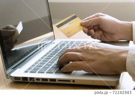 Man holding credit card and using laptop for shopping online. 72282983