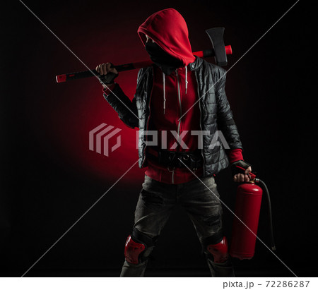 a man in a Balaclava and hoodie with an axe and a fire extinguisher the image of a Protestant a man in a Balaclava and hoodie with an axe and a fire extinguisher the image of a Protestant 72286287
