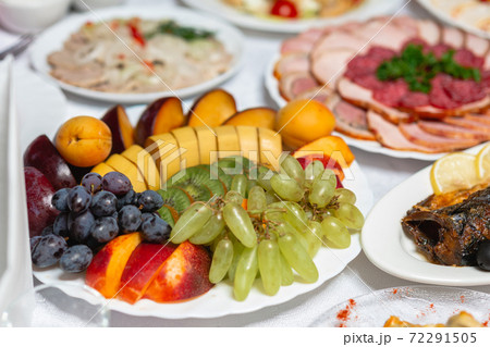 Table setting, food and decorations for important and family events, delicious snacks and hot dishes. Table setting, food and decorations for important and family events, delicious snacks and hot dishes. 72291505