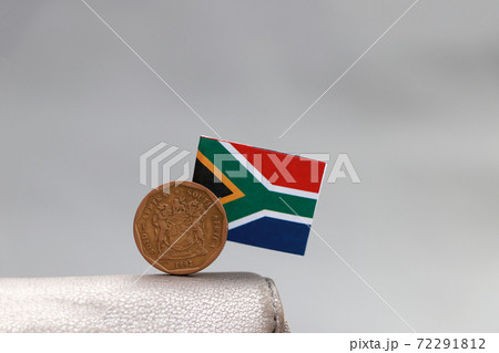 One coin of South African Rand money and mini South African flag stick on the leather wallet One coin of South African Rand money and mini South African flag stick on the leather wallet 72291812