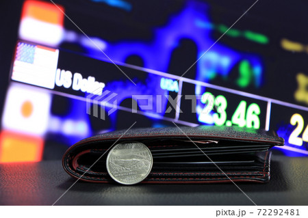 A quarter of US Dollar coins on reverse (USD) and black wallet on black floor A quarter of US Dollar coins on reverse (USD) and black wallet on black floor 72292481