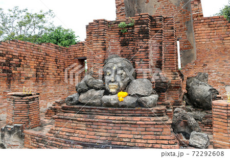 The ruins of stone Buddha pile together in the ruins and ancient church at Wat Worachet temple 72292608