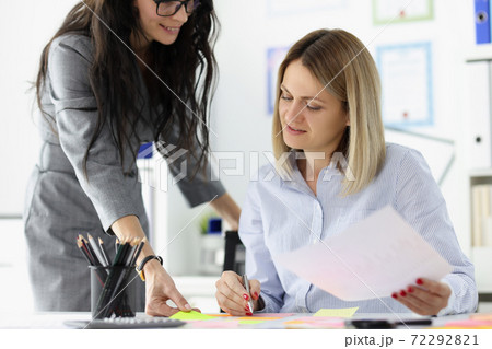 Businesswoman brought documents for signature to boss. Businesswoman brought documents for signature to boss. 72292821