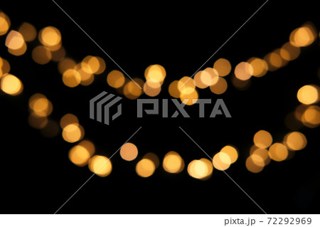 Blurred golden festive lights. Blurred garland backdrop for holidays and parties. Christmas Party concept Blurred golden festive lights. Blurred garland backdrop for holidays and parties. Christmas Party concept 72292969