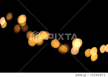 Blurred golden festive lights. Blurred garland backdrop for holidays and parties. Christmas Party concept Blurred golden festive lights. Blurred garland backdrop for holidays and parties. Christmas Party concept 72292971