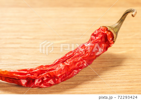 Close up dried red pepper on cutting board. Close up dried red pepper on cutting board. 72293424