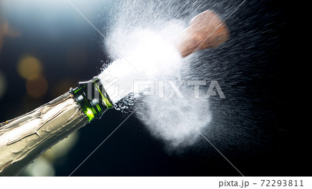 Detail of champagne wine splashing from bottle 72293811