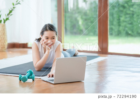 Beautiful asian woman staying fit by exercising at home for healthy trend lifestyle 72294190
