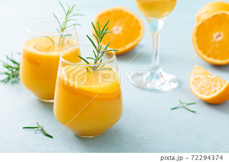 Summer refreshing honey bourbon cocktail with rosemary and orange juice Summer refreshing honey bourbon cocktail with rosemary and orange juice 72294374