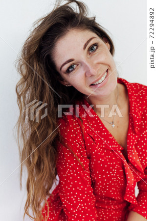 Portrait of a beautiful fashionable woman in a red dress Portrait of a beautiful fashionable woman in a red dress 72294892