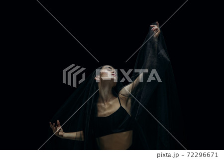 Graceful classic female ballet dancer isolated on black studio background. The grace, artist, movement, action and motion concept. Graceful classic female ballet dancer isolated on black studio background. The grace, artist, movement, action and motion concept. 72296671