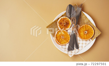 Gold setting of table with dry orange 72297501