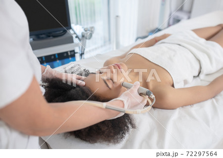 Young girl lying during cosmetic procedure 72297564