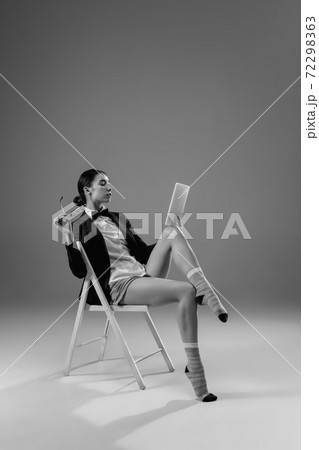 Young fashionable, stylish woman wearing jacket and socks working from home. Fashion during insulation 'cause of coronavirus pandemic Young fashionable, stylish woman wearing jacket and socks working from home. Fashion during insulation 'cause of coronavirus pandemic 72298363