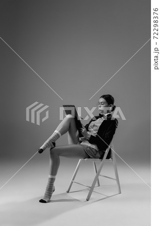 Young fashionable, stylish woman wearing jacket and socks working from home. Fashion during insulation 'cause of coronavirus pandemic 72298376