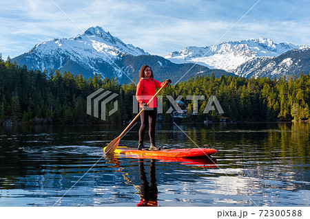 Adventurous Girl Paddle Boarding on Levette Lak 72300588
