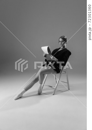 Young fashionable, stylish woman wearing jacket and socks working from home. Fashion during insulation 'cause of coronavirus pandemic 72301360