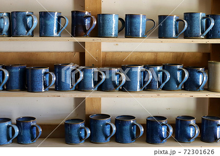 a display case is a display of dishes and kitchen utensils in a large store in Israel	 72301626