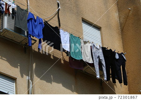 Clothesline drying on windows and balconies. Architectural details of housing in Israe Clothesline drying on windows and balconies. Architectural details of housing in Israe 72301867
