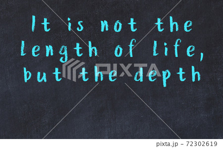 Chalk inscription of smart quote on black desk 72302619