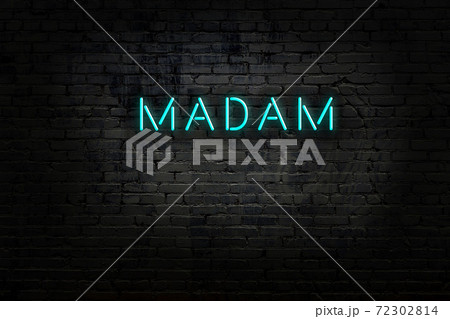 Night view of neon sign on brick wall 72302814
