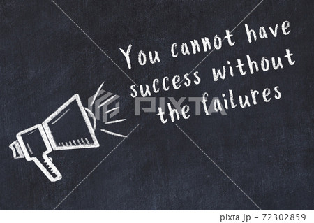 Chalk loudspeaker and wise quote on black desk 72302859