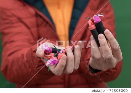 Man Holding Firecrackers in his Hand Man Holding Firecrackers in his Hand 72303000