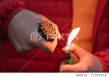 Man in Red Jacket Lighting Up Many Small Firecrackers Man in Red Jacket Lighting Up Many Small Firecrackers 72303018
