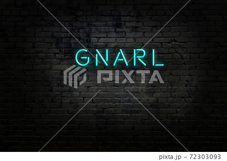 Night view of neon sign on brick wall 72303093