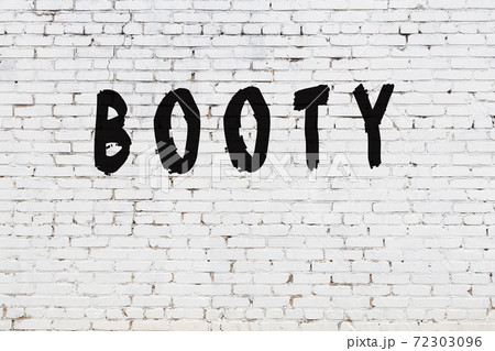 Word booty painted on white brick wall Word booty painted on white brick wall 72303096