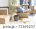 Business owner entrepreneur packing cardboard box preparing parcel for shipment, Online marketing.. 72303237