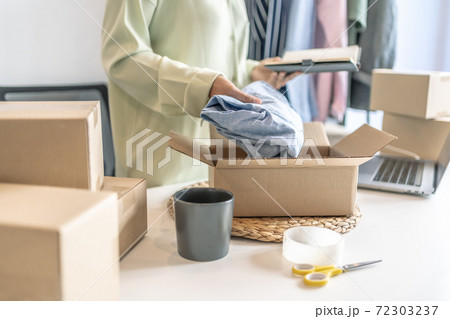 Business owner entrepreneur packing cardboard box preparing parcel for shipment, Online marketing.. Business owner entrepreneur packing cardboard box preparing parcel for shipment, Online marketing.. 72303237