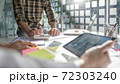 Startup business people teamwork calculating a valuation in workplace.. 72303240