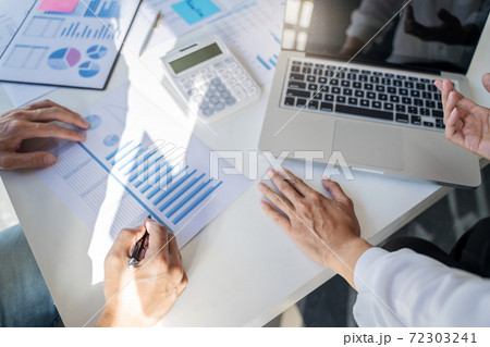 Business Startup team discussing on data report documents at modern workplace.. Business Startup team discussing on data report documents at modern workplace.. 72303241