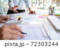 Business Startup team discussing on data report documents at modern workplace.. 72303244