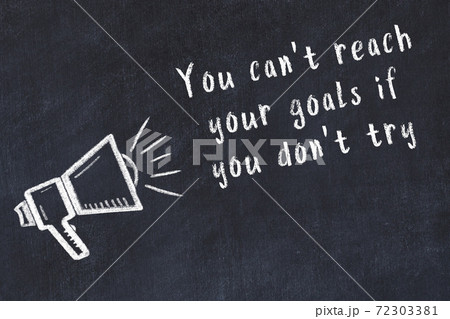 Chalk loudspeaker and wise quote on black desk 72303381