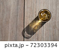 A cup of beer and ice on wooden table with sunlight and shadow. 72303394