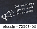 Chalk loudspeaker and wise quote on black desk 72303408
