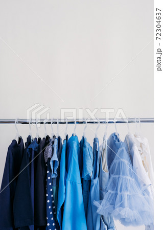 Fast fashion, Sustainable fashion, minimalist wardrobe. Variety of female blue clothing on hanging on white background with copy space. Fashion minimal style banner Fast fashion, Sustainable fashion, minimalist wardrobe. Variety of female blue clothing on hanging on white background with copy space. Fashion minimal style banner 72304637