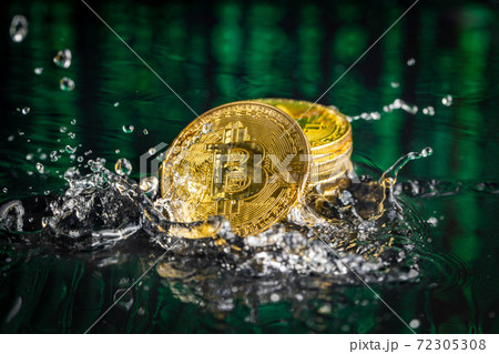 Gold bitcoin coin falling to water. Bitcoin and water splash. 72305308