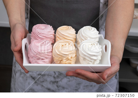 Homemade colorful marshmallows in the hands of a pastry chef. Appetizing dessert Homemade colorful marshmallows in the hands of a pastry chef. Appetizing dessert 72307150