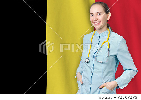 Kingdom of Belgium healthcare concept with doctor on flag background. Medical insurance, work or study in the country. Kingdom of Belgium healthcare concept with doctor on flag background. Medical insurance, work or study in the country. 72307279