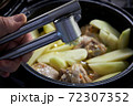 Garlic by the press is added to the dish of potatoes and turkey 72307352