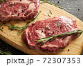 Two raw beef slices for barbecue on wooden board 72307353