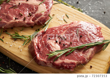 Two raw beef slices for barbecue on wooden board Two raw beef slices for barbecue on wooden board 72307353