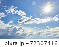 Beautiful fluffy clouds on a blue sky background on a sunny day 72307416