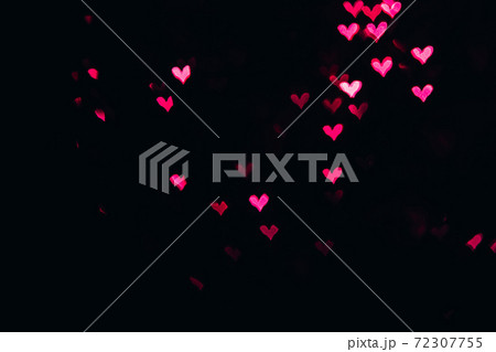 Defocused bokeh lights in shape of pink and red hearts. 72307755